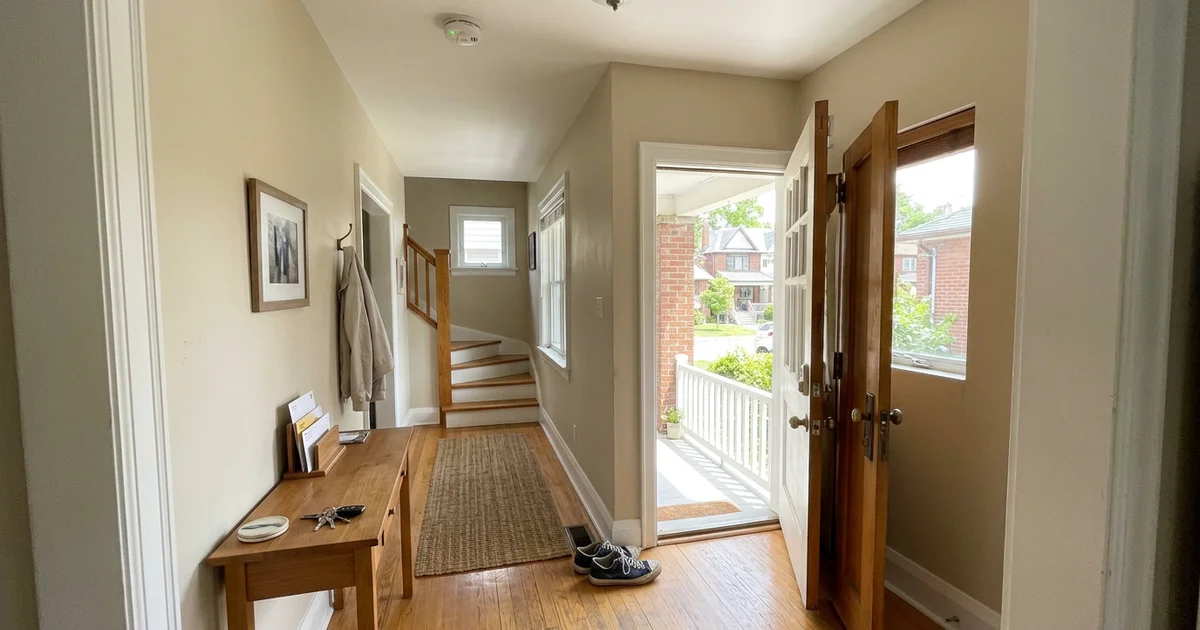 Clear hallway with a working smoke alarm and an open exit door
