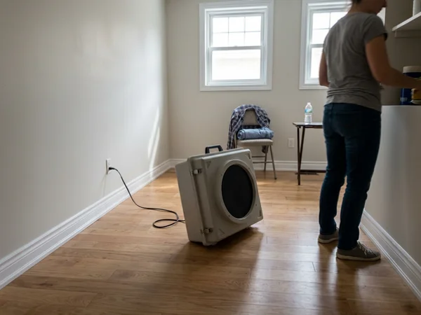 Air scrubber running in a cleared basement room