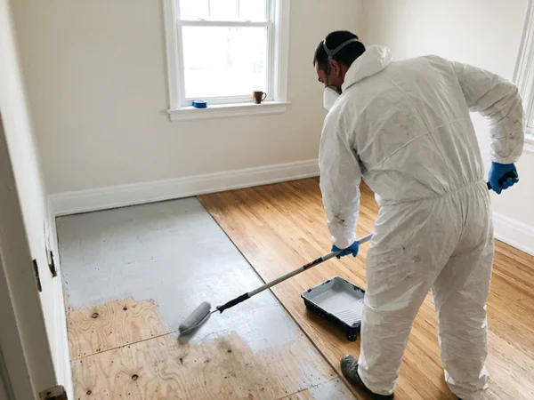 Encapsulating primer applied to exposed subfloor