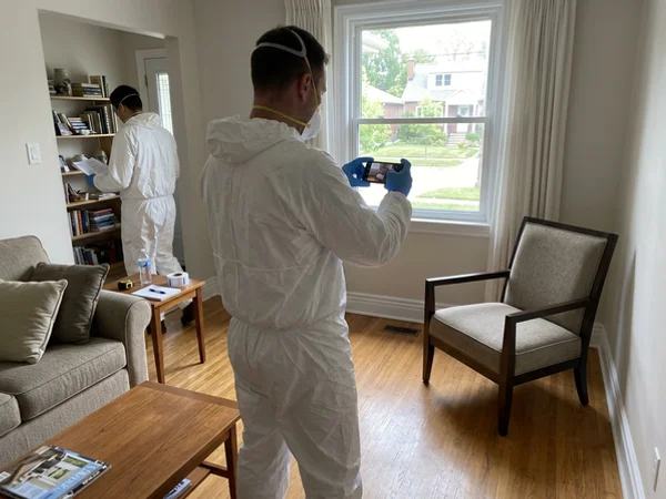 Crew member photographing furniture for an estate inventory