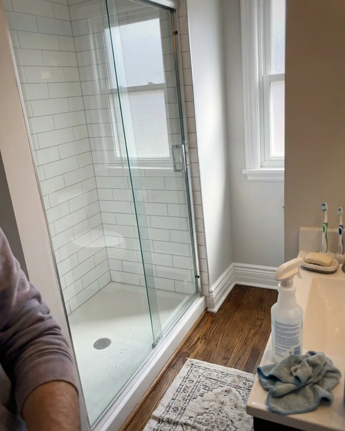 Gleaming bathroom tiles and shower after extreme cleaning