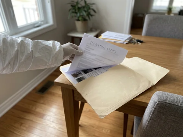 Completion letter and photo log placed into a folder