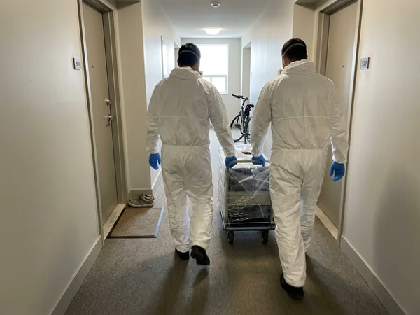Crew moving a covered dolly down a condo hallway