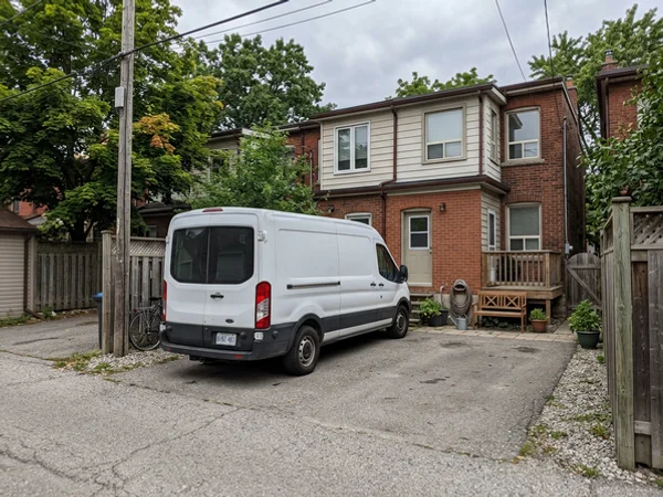 Unmarked van parked in a rear laneway