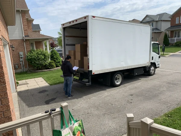 Unmarked box truck backed into a private driveway